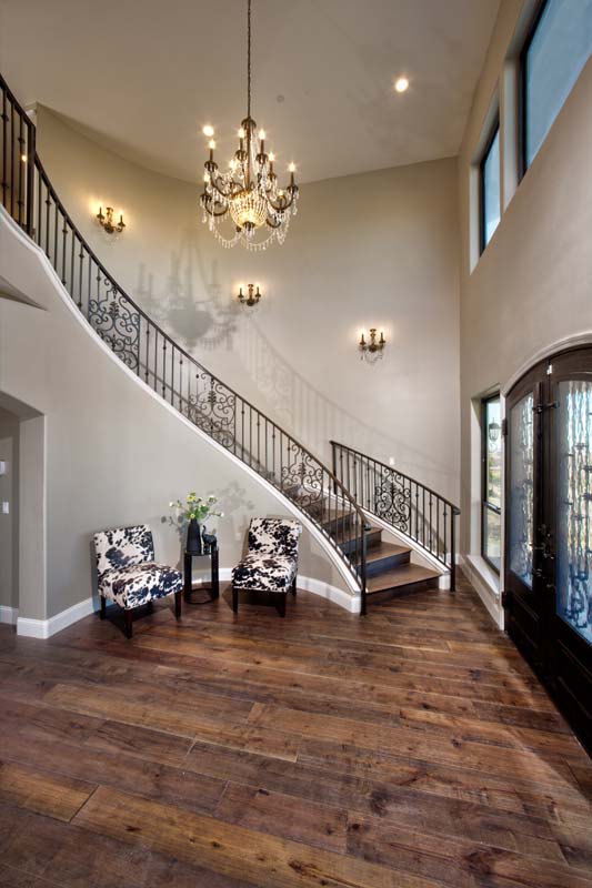 home entry with stairs railing and chandelier