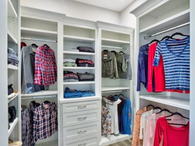 A beautifully designed walk in closet with lots of space for him and her.